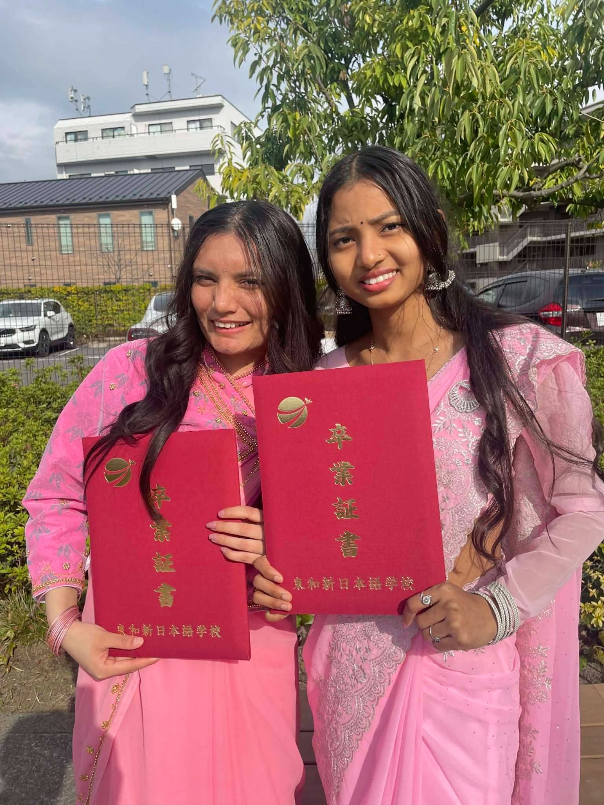 Birkausalya students holding graduation certificates